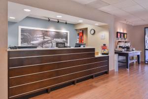 a lobby of a hotel with a cashier and a counter at Hampton Inn by Hilton Decatur in Decatur