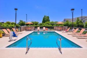 a large swimming pool with chairs and umbrellas at Hampton Inn by Hilton Decatur in Decatur