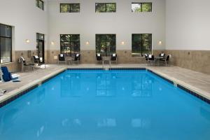 a swimming pool with blue water in a building at Hampton Inn & Suites Athens/Interstate 65 in Athens