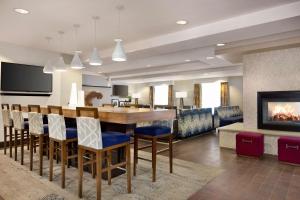 a living room with a bar and a fireplace at Hampton Inn Denver-West/Golden in Golden
