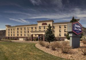 a hotel building with a sign in front of it at Hampton Inn & Suites Denver Littleton in Littleton