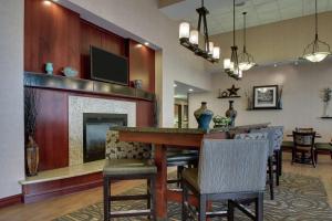 a living room with a bar and a fireplace at Hampton Inn & Suites Denver Littleton in Littleton