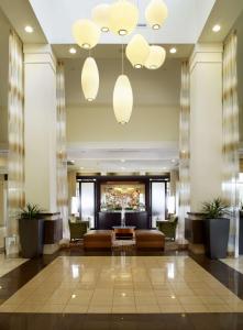a lobby of a hotel with couches and plants at Hilton Garden Inn Dallas Arlington in Arlington
