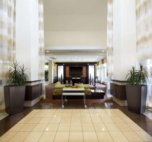 a lobby with a couch and a table in a building at Hilton Garden Inn Dallas Arlington in Arlington