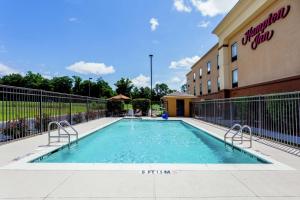 a swimming pool in front of a hotel at Hampton Inn Ozark in Ozark