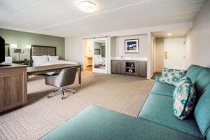 a living room with a couch and a bed at Hampton Inn Dover in Dover