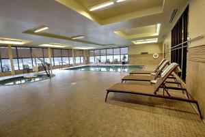 a swimming pool with lounge chairs in a building at Homewood Suites by Hilton, Durango in Durango