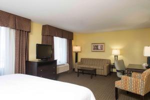 a hotel room with a bed and a television at Hampton Inn & Suites Danville in Danville
