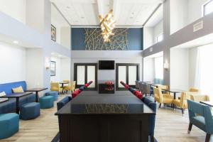 a dining room with a table with baseball bats on it at Hampton Inn & Suites Ankeny in Ankeny