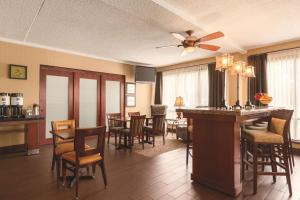 a living room with a bar and a dining room at Hampton Inn Des Moines-Airport in Des Moines