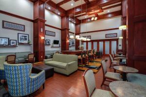 a lobby with tables and chairs and a bar at Hampton Inn & Suites Detroit/Chesterfield in Chesterfield