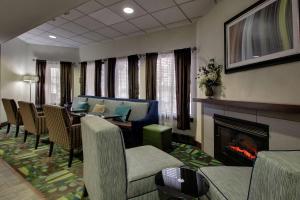 a living room with a fireplace and a table and chairs at Hampton Inn DuBois in DuBois