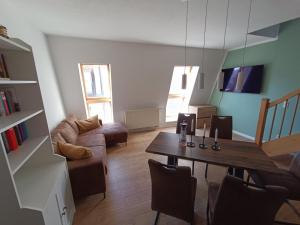 a living room with a table and a couch at FeWo Vineta in Barth