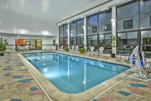 a large swimming pool in a building with a hotel at Hampton Inn Detroit/Belleville-Airport Area in Belleville