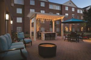 a patio with chairs and tables in front of a building at Homewood Suites by Hilton Detroit-Troy in Birmingham