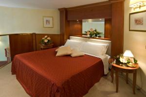 una camera con letto e piumone rosso di AS Hotel Monza a Monza