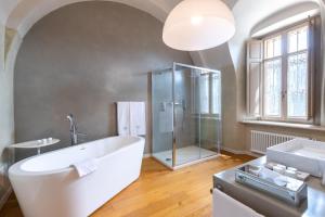 a bathroom with a tub and a shower and a sink at Relais Villa del Borgo in Canelli