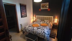 a bedroom with a bed and two orange pillows on it at Hotel Casa Grande in Constantina