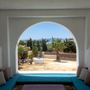 una ventana arqueada en una habitación con piscina en Άνεσις διαμέρισμα στην Πάρο en Aliki