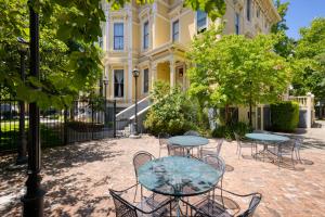 a group of tables and chairs in front of a building at HI Sacramento Hostel in Sacramento