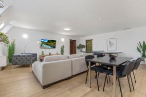 a living room with a white couch and a table at Family Hub in Centre in Bratislava