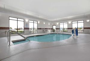 a large swimming pool in a building with windows at Hampton Inn Keokuk in Keokuk