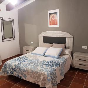 a bedroom with a large bed and a mirror at Masia cerca del río muga in Terrades