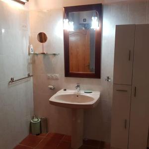 a bathroom with a sink and a mirror at Masia cerca del río muga in Terrades