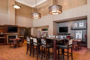 a dining room with a table and chairs at Hampton Inn & Suites West Bend in West Bend