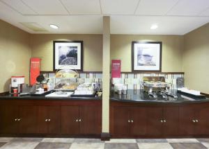 a restaurant with a counter with food on it at Hampton Inn North Brunswick NJ in North Brunswick