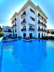 a large swimming pool in front of a hotel at Nova Butik Hotel Çeşme in Cesme