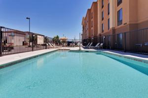 a large swimming pool in front of a building at Hampton Inn & Suites Fresno - Northwest in Herndon