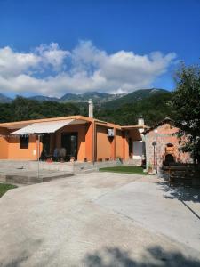 a house with an orangeructure with mountains in the background at Apartman Petovic in Kotor