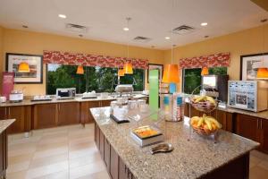 a large kitchen with a counter with fruit on it at Hampton Inn Fayetteville Fort Liberty in Fayetteville