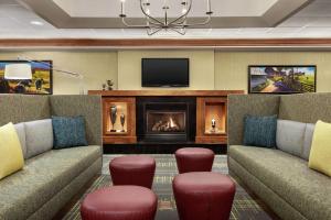 a living room with two couches and a fireplace at Hampton Inn & Suites Frederick/Fort Detrick in Frederick