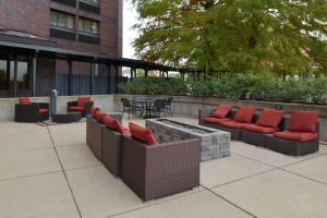 a patio with couches and a table and chairs at Hampton Inn Frederick in Frederick
