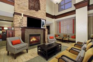 a living room with a fireplace and a tv at Hampton Inn & Suites-Florence Downtown in Florence