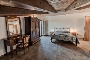 a bedroom with a bed and a dresser and a desk at Agri Charme Tenuta Picilli in Albanella