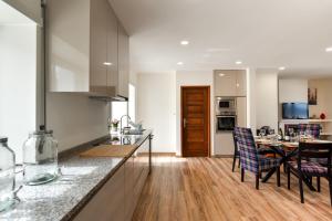 a kitchen and dining room with a table and chairs at Feel Discovery Quinta do Muro in Peso da Régua