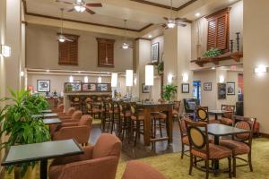 a restaurant with tables and chairs in a room at Hampton Inn & Suites Florence-North-I-95 in Florence