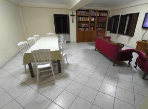 a dining room with a white table and chairs at La Locanda del Convento in Tropea