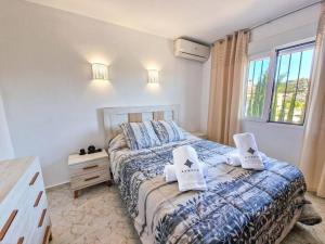 a bedroom with a bed with two pillows on it at Villa cerca del pueblo y playas de Moraira - Ref A022 AVANOA PREMIUM RENTALS in Moraira