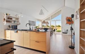a kitchen with wooden cabinets and a large island at Beautiful Home In Slagelse With Wifi in Slagelse