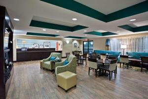 a waiting area in a hospital with tables and chairs at Hampton Inn North Sioux City in North Sioux City