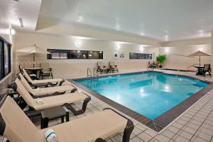 a large pool in a hotel room with lounge chairs at Hampton Inn North Sioux City in North Sioux City