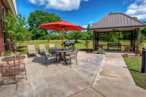 a patio with a table and chairs and an umbrella at Hampton Inn Clarksville in Clarksville