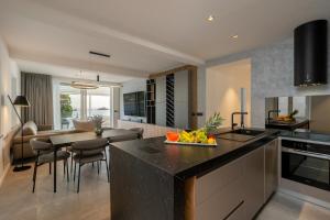 a kitchen and living room with a table with a bowl of fruit at Levanat in Dubrovnik