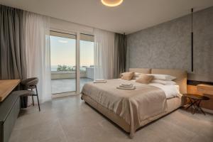 a bedroom with a large bed and a balcony at Levanat in Dubrovnik