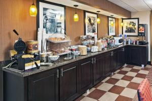 a kitchen with a counter with food on it at Hampton Inn Clarksville in Clarksville