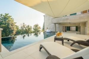 a house with a swimming pool and a patio at Levanat in Dubrovnik